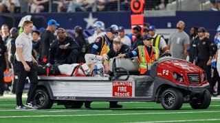 ARLINGTON, TX – OCTOBER 13: Detroit Lions defensive end Aidan Hutchinson (97) is carted of the field with an aircast on his left leg during the game between the Dallas Cowboys and the Detroit Lions on October 13, 2024 at AT&T Stadium in Arlington, Texas. (Photo by Matthew Pearce/Icon Sportswire via Getty Images)