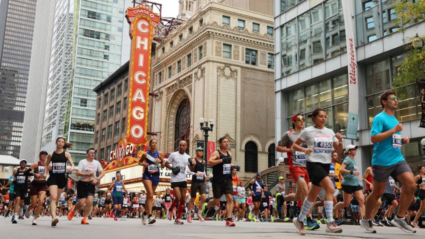 CHICAGO, ILLINOIS – OCTOBER 13: Runners pass the Chicago Theatre during the 2024 Chicago Marathon on October 13, 2024 in Chicago, Illinois. (Photo by Michael Reaves/Getty Images)