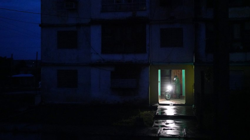 A motorcycle driver is seen in the lobby of a building during a nationwide blackout caused by a grid failure in Matanzas, Cuba, on October 18, 2024. Technical breakdowns, fuel shortages and high demand have caused the country’s thermoelectric power plants to constantly fail, forcing the government to declare an energy emergency and take measures such as closing schools and factories.