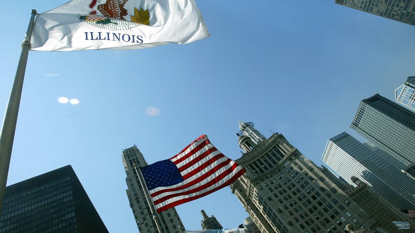 Flags flutter in the wind in downtown Chicago 02 July 2003. Chicago is the starting point of Route 66, often called “America’s Main Street” and is 2,448 miles (3,939 km) of roadway which from 1926 to 1984 linked small towns and urban communities from Chicago to Los Angeles. By 1984 the old road and many of the small towns through which it passed were largely abandoned in favor of the newly completed high-speed interstate highway system. The remnants of what is now known as “historic Route 66” is still visited by nostalgia-seekers and road enthusiasts interested in rediscovering the pleasures of small town America.  AFP PHOTO / Robyn BECK (Photo by Robyn BECK / AFP) (Photo by ROBYN BECK/AFP via Getty Images)