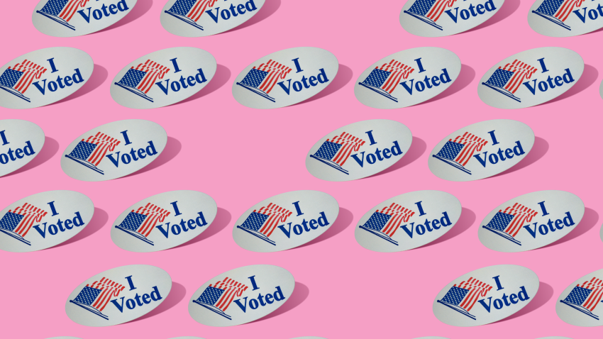 "I voted" stickers arranged on a pink background.