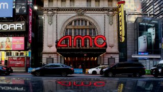 Cars drive near an AMC Theater in New York City on March 29, 2023.