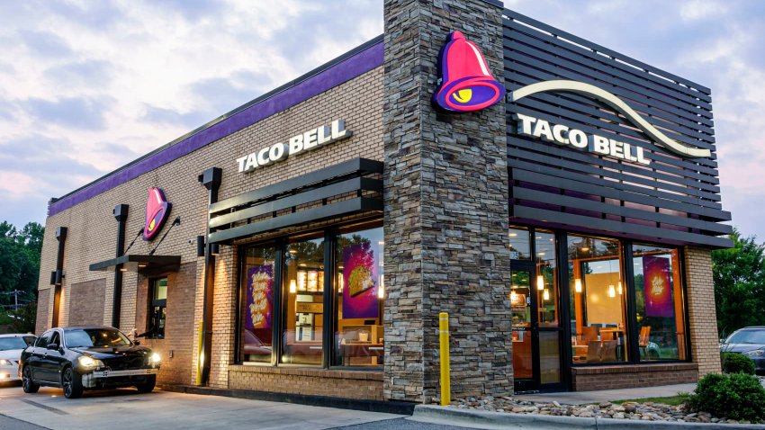 A Taco Bell fast-food restaurant and drive-thru at dusk in Gastonia, North Carolina.