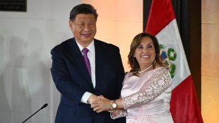 China’s President Xi Jinping (L) and Peru’s President Dina Boluarte shake hands during a meeting at the government palace in Lima on November 14, 2024, on the sidelines of the Asia-Pacific Economic Cooperation (APEC) Summit. 