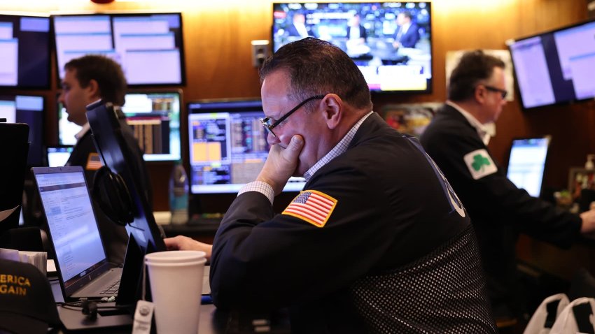 A trader works on the floor of the New York Stock Exchange (NYSE) at the opening bell on November 26, 2024, in New York City. 