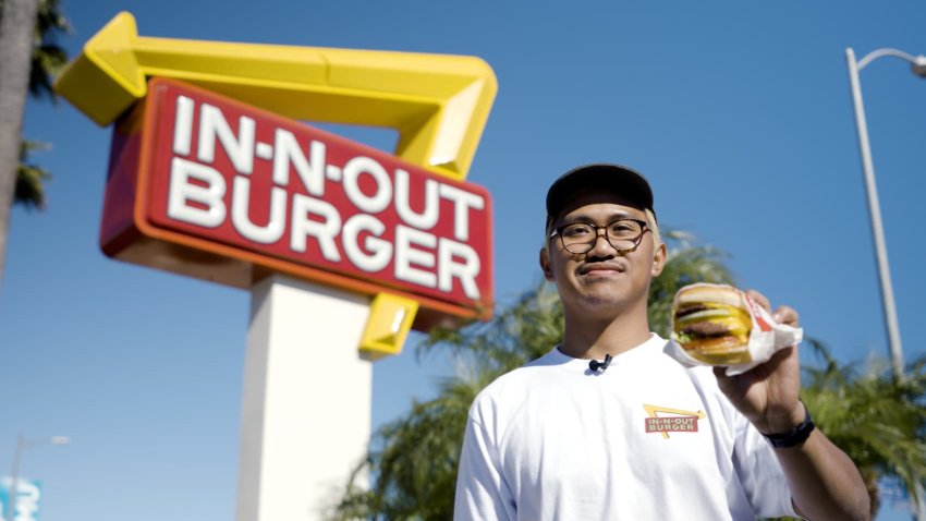 Cy Soliman holds a burger outside of In-N-Out.