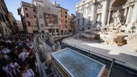 A small pool is seen in front of the Trevi Fountain to allow tourists to throw their coins in it, as the fountain has been emptied to undergo maintenance work that it is expected to be completed by the end of the year, in Rome, Friday, Nov. 1, 2024.