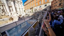 A small pool is seen in front of the Trevi Fountain to allow tourists to throw their coins in it, as the fountain has been emptied to undergo maintenance work that it is expected to be completed by the end of the year, in Rome, Friday, Nov. 1, 2024. (AP Photo/Andrew Medichini)