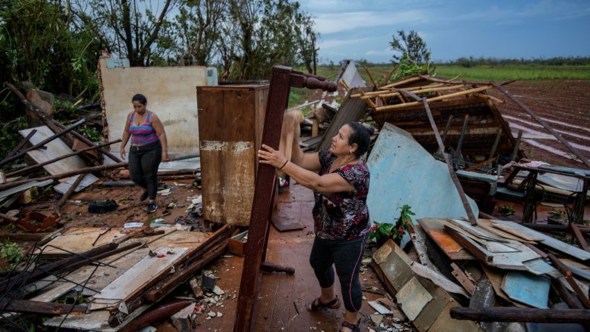 People recover belongings from their houses, which were destroyed by Hurricane Rafael, in Alquizar, Cuba