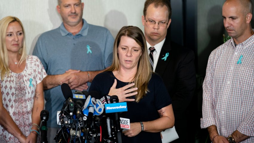 Nichole Schmidt, mother of Gabby Petito, whose death on a cross-country trip has sparked a manhunt for her boyfriend Brian Laundrie, speaks alongside, from left, Tara Petito, stepmother, Joseph Petito, father, Richard Stafford, family attorney, and Jim Schmidt, stepfather, during a news conference, Sept. 28, 2021, in Bohemia, N.Y.