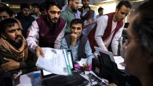 Afghan applicants crowd into a cafe