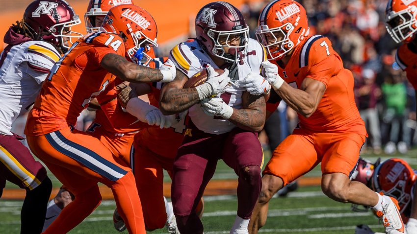 CHAMPAIGN, ILLINOIS – NOVEMBER 2: Darius Taylor #1 of the Minnesota Golden Gophers runs the ball as Xavier Scott #14 and Matthew Bailey #7 of the Illinois Fighting Illini converge for the tackle during the first half at Memorial Stadium on November 2, 2024 in Champaign, Illinois.  (Photo by Michael Hickey/Getty Images)