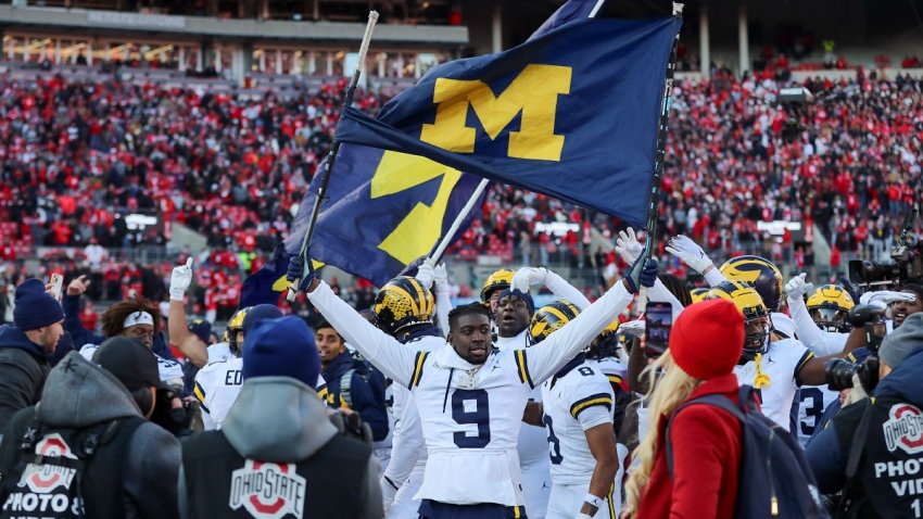 COLUMBUS, OH – NOVEMBER 30: Michigan Wolverines defensive back Rod Moore (9) holds up a Michigan flag at midfield after the game against the Michigan Wolverines and the Ohio State Buckeyes on November 30, 2024, at Ohio Stadium in Columbus, OH. (Photo by Ian Johnson/Icon Sportswire via Getty Images)