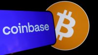 The Coinbase and bitcoin logos are displayed on a phone screen in San Anselmo, California, on Feb. 15, 2024.