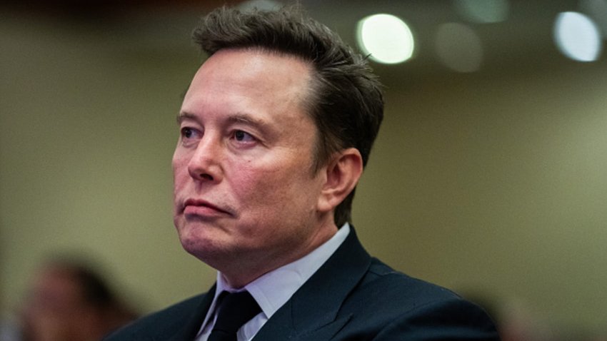 Elon Musk listens as US President-elect Donald Trump speaks during a House Republicans Conference meeting at the Hyatt Regency on Capitol Hill on November 13, 2024 in Washington, DC.