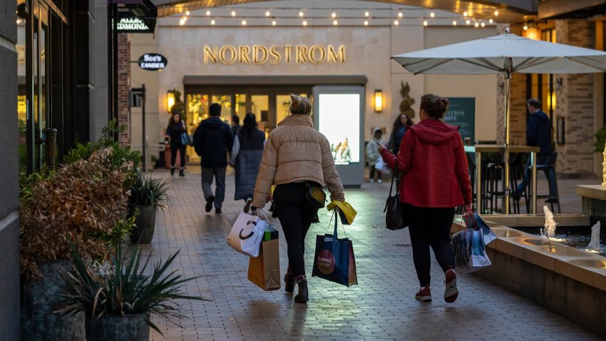 Shoppers carry bags at Broadway Plaza in Walnut Creek, California, US, on Monday, Dec. 16, 2024. The Bureau of Economic Analysis is scheduled to release personal spending figures on December 20. 
