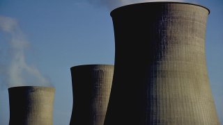 These are the iconic cooling towers of a nuclear power plant. these oversized smoke stacks vent steam form the Power plant These were shot in Winfield, West Virginia, USA. 