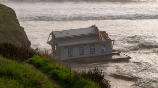 The remnants of a restaurant float at the head of the San Lorenzo River in Santa Cruz, Calif., Monday, Dec. 23, 2024.