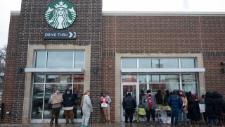 Starbucks Workers United members picket outside a Starbucks store in Chicago, Illinois, US, on Friday, Dec. 20, 2024. The union, which represents employees at more than 500 of Starbucks’ US 10,000 company-operated stores, said workers decided to go on strike after the coffee chain presented a package that offered no immediate raises for baristas in the union. Photographer: Vincent Alban/Bloomberg via Getty Images