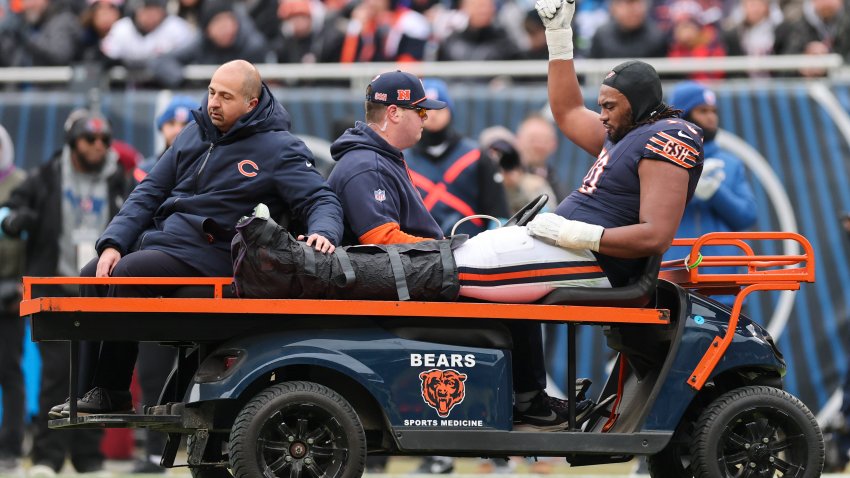 CHICAGO, ILLINOIS – DECEMBER 22: Braxton Jones #70 of the Chicago Bears is taken off the field after being injured against the Detroit Lions during the second quarter at Soldier Field on December 22, 2024 in Chicago, Illinois. (Photo by Michael Reaves/Getty Images)