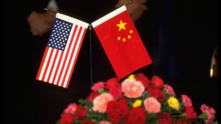 Amer. & Chinese flags table decorations during US/China ceremony renewing 1989 MOA Memo of Agreement re Intl.