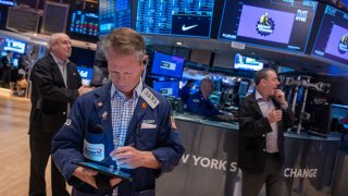 Traders work on the floor of the New York Stock Exchange on the last day of trading for the year on Dec. 31, 2024.