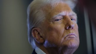 U.S. President Donald Trump looks on as reporters ask questions aboard Air Force One during a flight from Las Vegas, Nevada, to Miami, Florida, U.S., January 25, 2025.