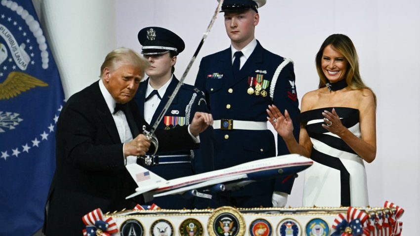 First Lady Melania Trump laughs as she watches US President Donald Trump cut with a saber into a cake representation of the new Air Force One design during the Commander-In-Chief inaugural ball at the Walter E. Washington Convention Center in Washington, DC, on Jan. 20, 2025.
