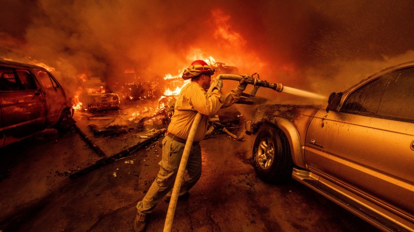 A firefighter battles the Eaton Fire