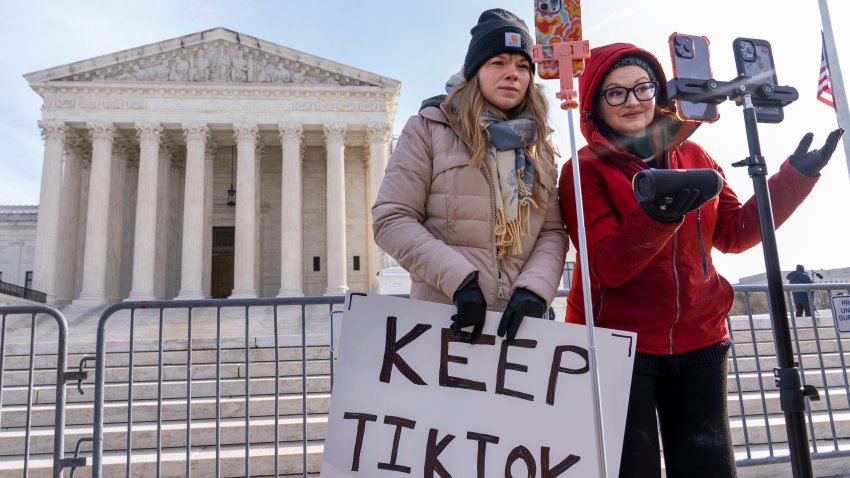 Sarah Baus, left, of Charleston, S.C., and Tiffany Cianci, who says she is a "long-form educational content creator," livestream to TikTok outside the Supreme Court, Friday, Jan. 10, 2025, in Washington.