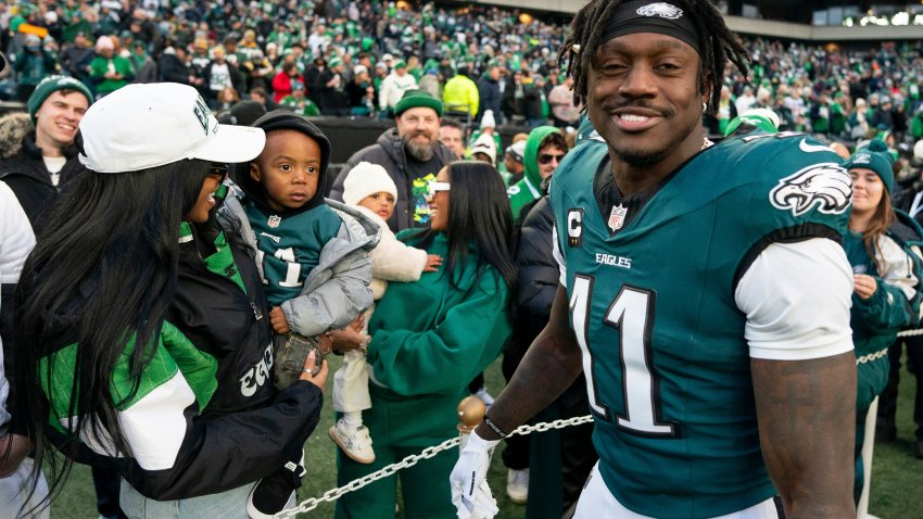 Philadelphia Eagle wide receiver A.J. Brown (11) looks on after talking with his son before an NFL wild-card playoff football game against the Green Bay Packers, Sunday, Jan. 12, 2025, in Philadelphia.