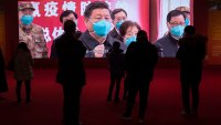 FILE - People attend an exhibition on the city's fight against the coronavirus in Wuhan in central China's Hubei province, Jan. 23, 2021.