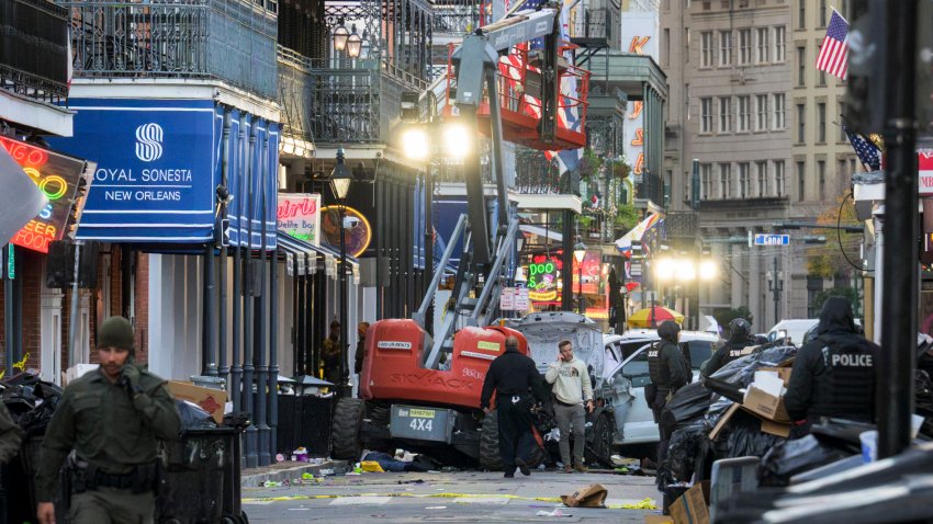 Police investigators surround a white truck that has been crashed into a work lift in the French Quarter of New Orleans, Louisiana, on January 1, 2025. At least 10 people were killed and 30 injured Wednesday when a vehicle plowed overnight into a New year’s crowd in the heart of the thriving New Orleans tourist district, authorities in the southern US city said. (Photo by Matthew HINTON / AFP) (Photo by MATTHEW HINTON/AFP via Getty Images)