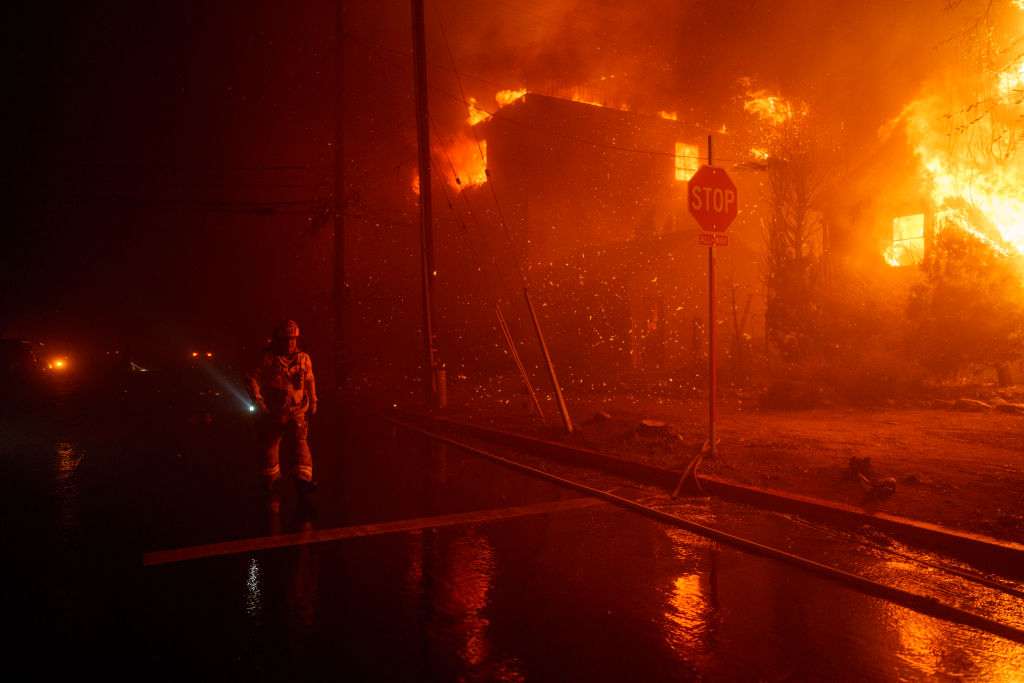 Firefighters battle flames from the Palisades Fire on January 7, 2025 in the Pacific Palisades neighborhood of Los Angeles, California.