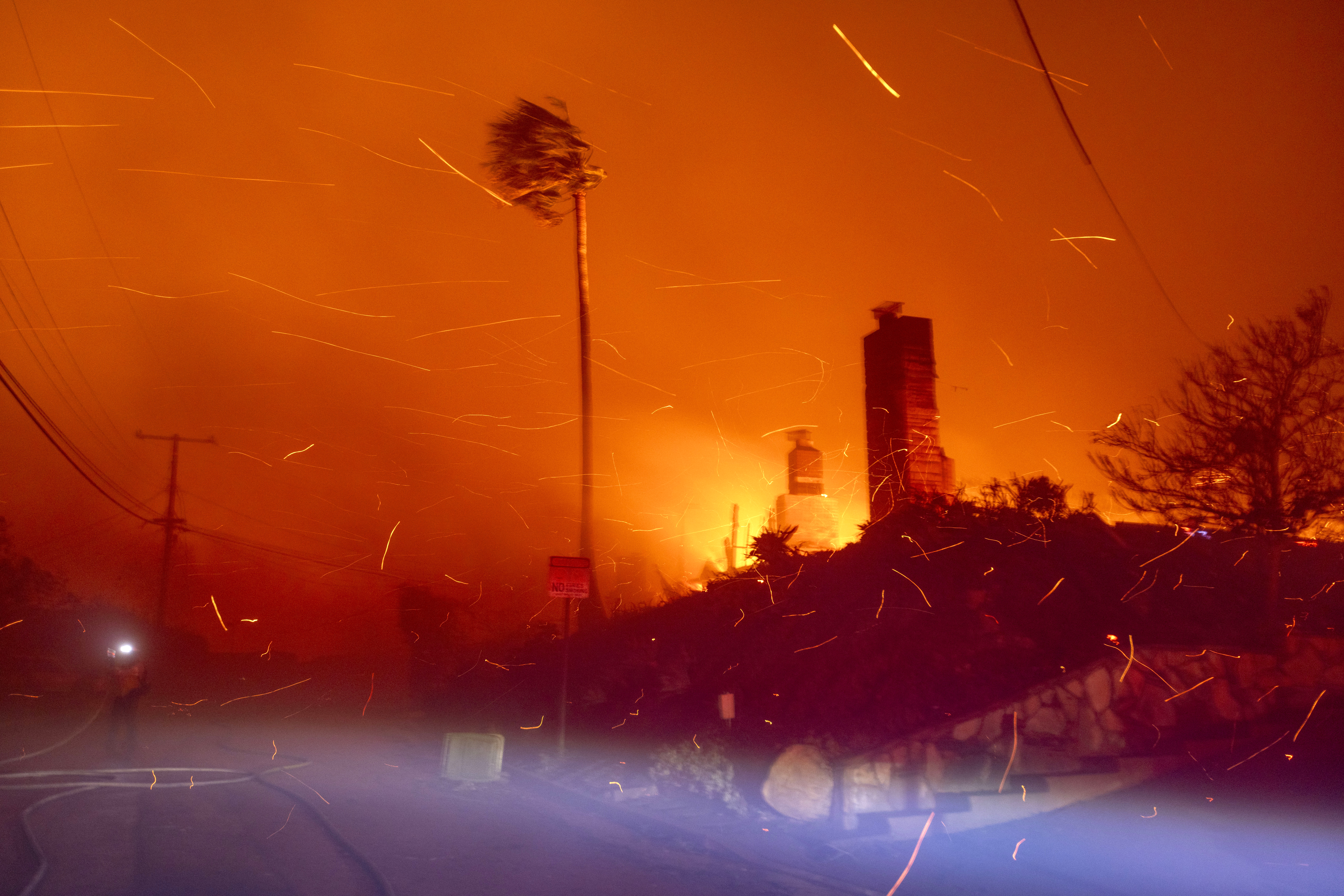 A firefighter battles the blaze on El Medio Avenue during the Palisades Fire in the Pacific Palisades neighborhood of Los Angeles, California, US, on Tuesday, Jan. 7, 2025. Photographer: Jill Connelly/Bloomberg via Getty Images