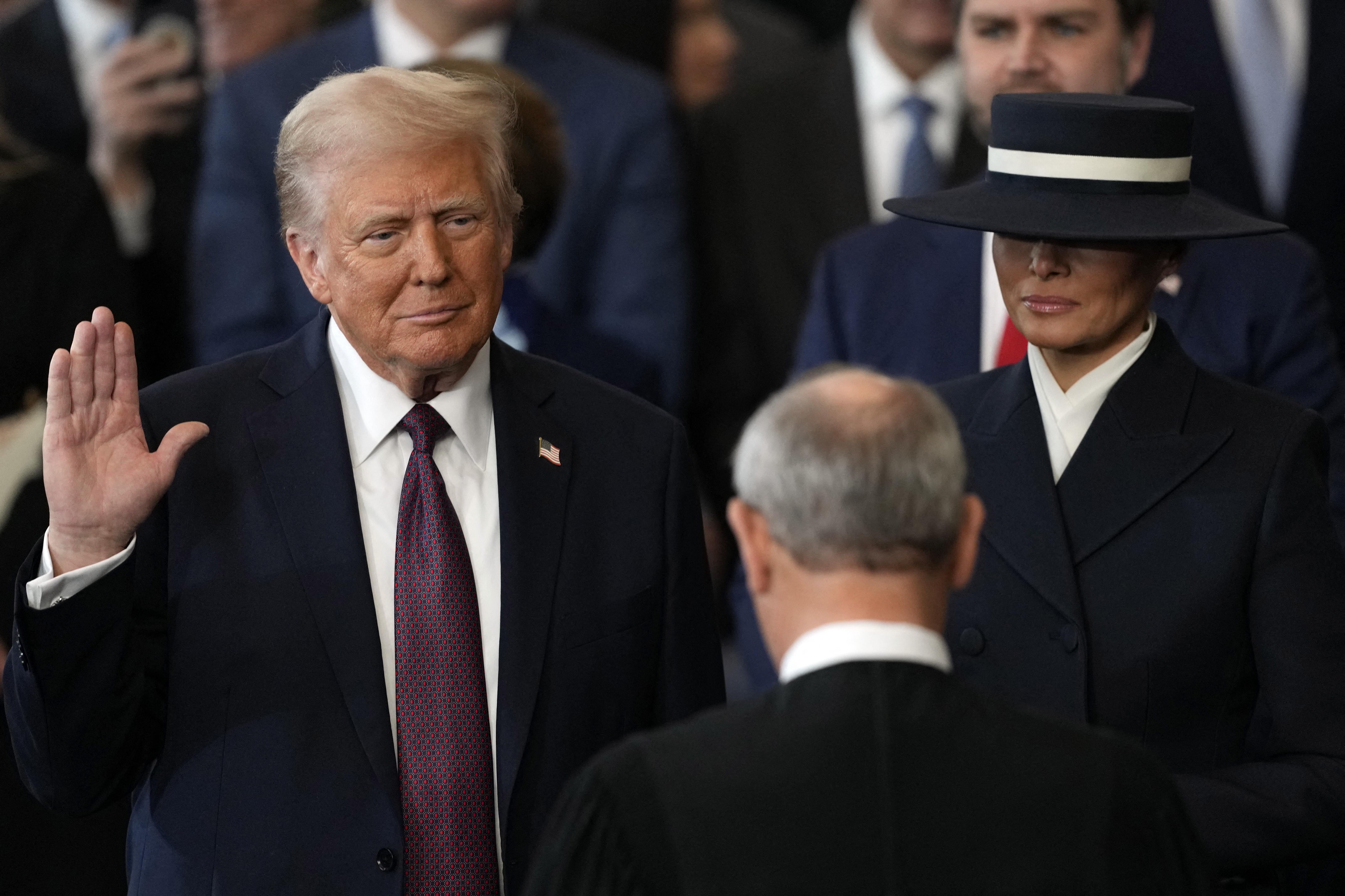 Donald Trump is sworn in as the 47th president of the United States by Chief Justice John Roberts as Melania Trump holds the Bible in the US Capitol Rotunda in Washington, DC, on January 20, 2025. Donald Trump is sworn in as the 47th president of the United States by Chief Justice John Roberts as Melania Trump holds the Bible (Photo by Julia Demaree Nikhinson / AFP) (Photo by JULIA DEMAREE NIKHINSON/AFP via Getty Images)