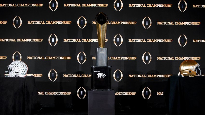 ATLANTA, GA – JANUARY 19: A general view of the National Championship Trophy Presented by Dr. Pepper with the helmets of the Notre Dame Fighting Irish and the Ohio State Buckeyes before the start of the CFP National Championship Head Coaches News Conference at the Westin Peachtree Plaza Hotel on January 19, 2025 in Atlanta, Georgia. (Photo by Don Juan Moore/Getty Images)