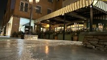 An icy sidewalk with caution tape surrounds DeNucci's Restaurant in Highland Park, Illinois on Jan. 22, 2025