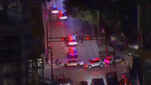 Miami police are investigating a death in downtown Thursday morning, and may have detained a suspect who was armed with a stick.
