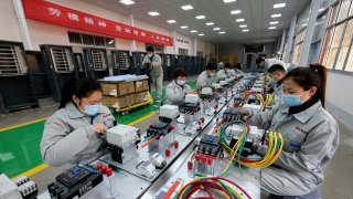 Workers make charging equipment for new energy vehicles at a workshop of Shandong Dingsheng Electric Equipment in Zaozhuang, east China’s Shandong province.