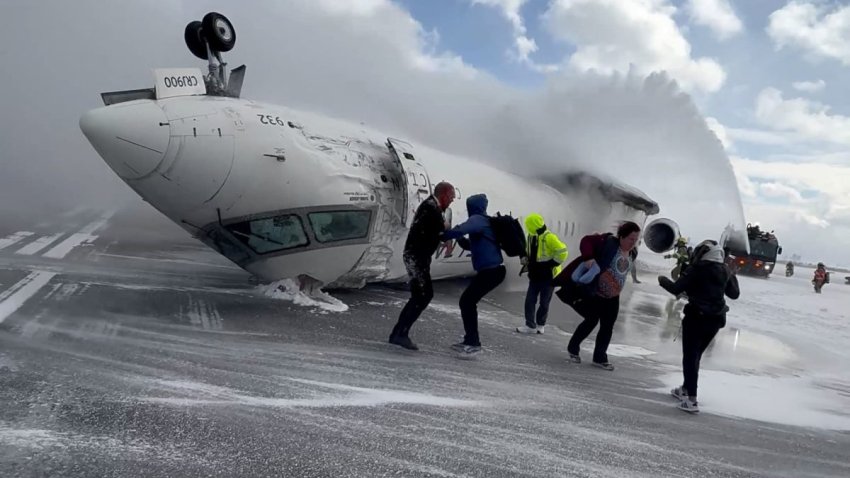 Passengers leave a Delta Air Lines CRJ-900 jet after it crashed on landing at Toronto Pearson International Airport in Mississauga, Ontario, Canada Feb. 17, 2025 in a still image from video. 