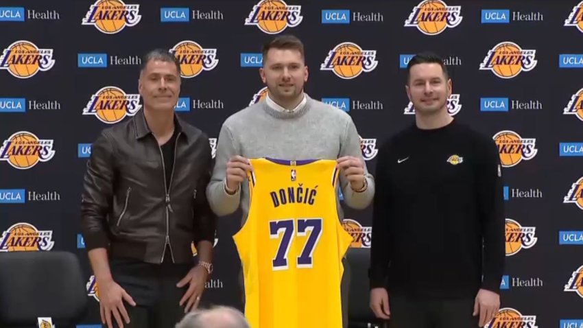 Luka Doncic (center) appears alongside Lakers general manager Rob Pelinka and coach JJ Reddick Tuesday Feb. 4, 2025.