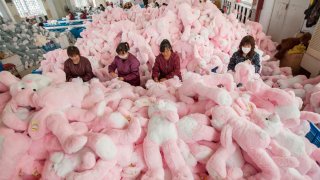 Employees manufacture toys at a workshop in Lianyungang, Jiangsu province of China.