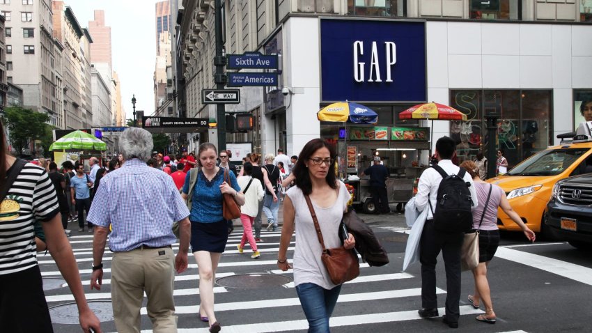 Pedestrians pass in front of a Gap store in New York.