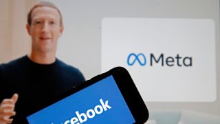 In this photo illustration, the Facebook logo is displayed on the screen of an iPhone in front of a Meta logo on October 28, 2021 in Paris, France.