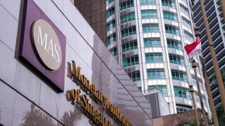 Signage for the Monetary Authority of Singapore is displayed outside the central bank’s headquarters in Singapore, on October 22, 2019. Singapore’s central bank tightened its monetary policy on Thursday, saying the widely forecast move will slow the inflation momentum.