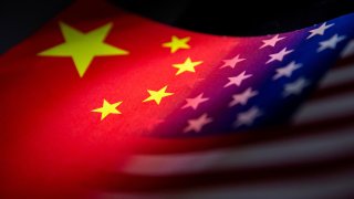 China’s and U.S.’ flags are seen printed on paper in this illustration taken January 27, 2022. 