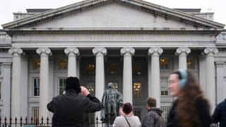 People take pictures of the U.S. Treasury Department building in Washington, D.C., on Feb. 6, 2025.