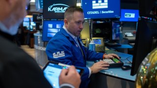 Traders work on the floor of the New York Stock Exchange on Feb. 13, 2025.