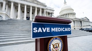 A “Save Medicaid” sign is affixed to the podium for the House Democrats’ press event to oppose the Republicans’ budget on the House steps of the Capitol on Tuesday, February 25, 2024. 
